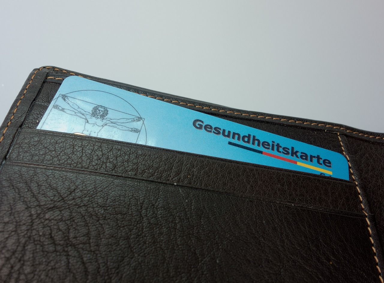 A health insurance card tucked into a wallet